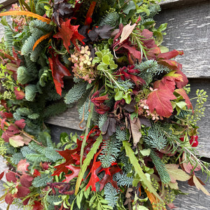Fresh Autumnal wreath with green, red, and orange leaves